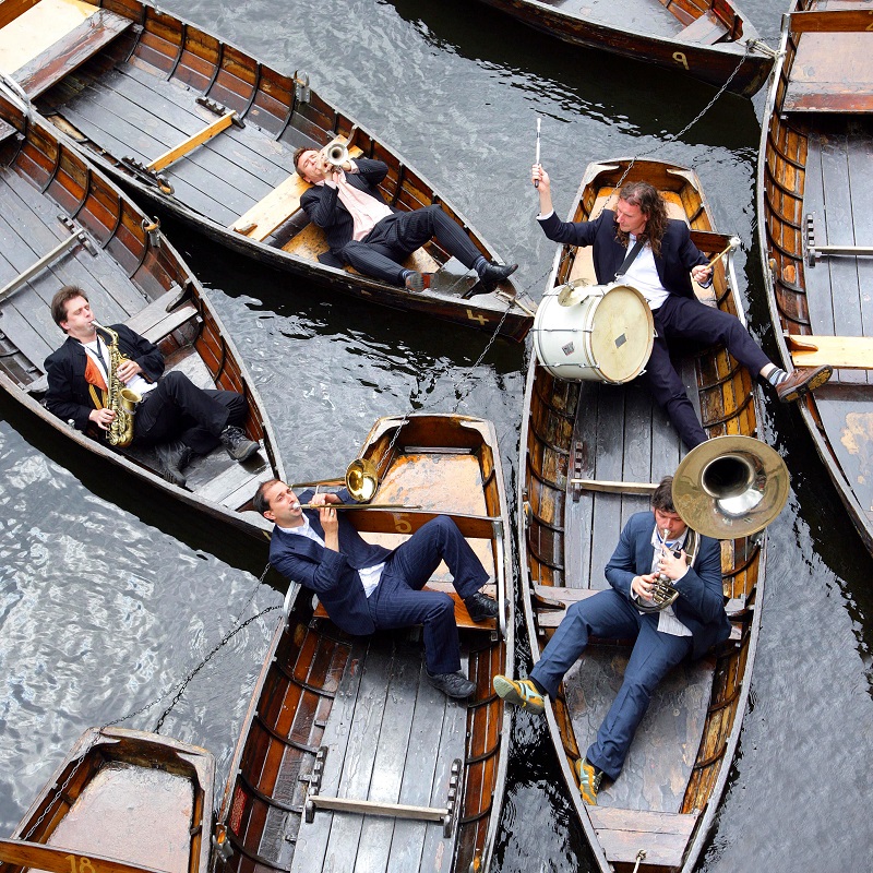Musicians play a floating concert on rowing boats